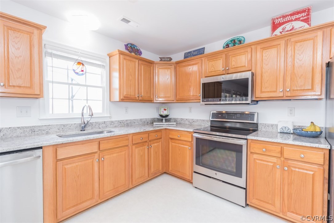 4829 Wakema Road West Point, VA 23181 - Photo 7 of 36 a kitchen with granite countertop a sink stainless steel appliances and cabinets