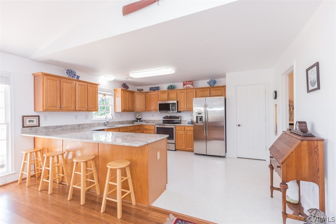 4829 Wakema Road West Point, VA 23181 - Photo 8 of 36 a kitchen with stainless steel appliances kitchen island granite countertop a refrigerator and a stove top oven