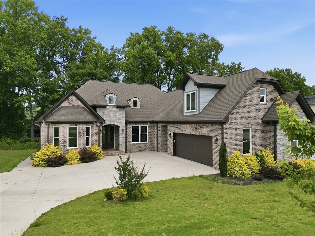 105 Bree Drive Anderson, SC 29621 - Photo 46 of 48 A well-maintained lawn and mature trees frame this elegant brick and stone residence.