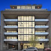 a front view of a building with glass windows and a door