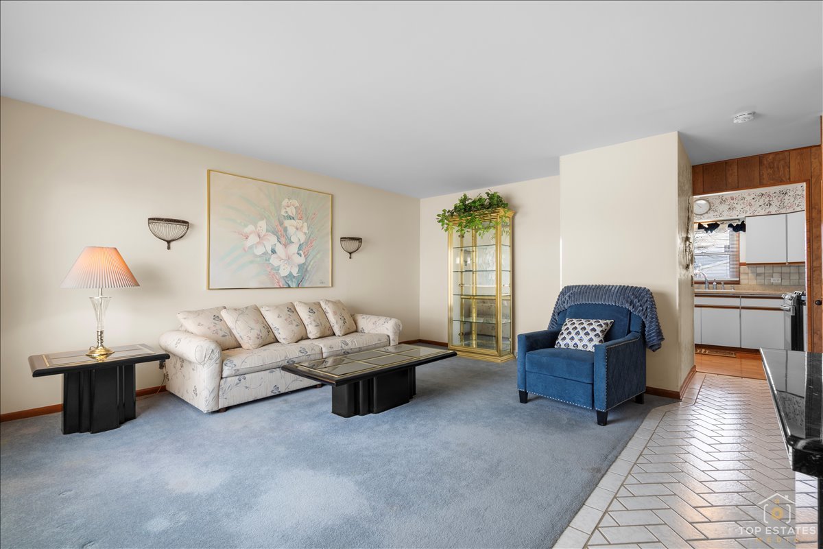 216 Evergreen Street Addison, IL 60101 - Photo 11 of 43 a living room with furniture and a lamp