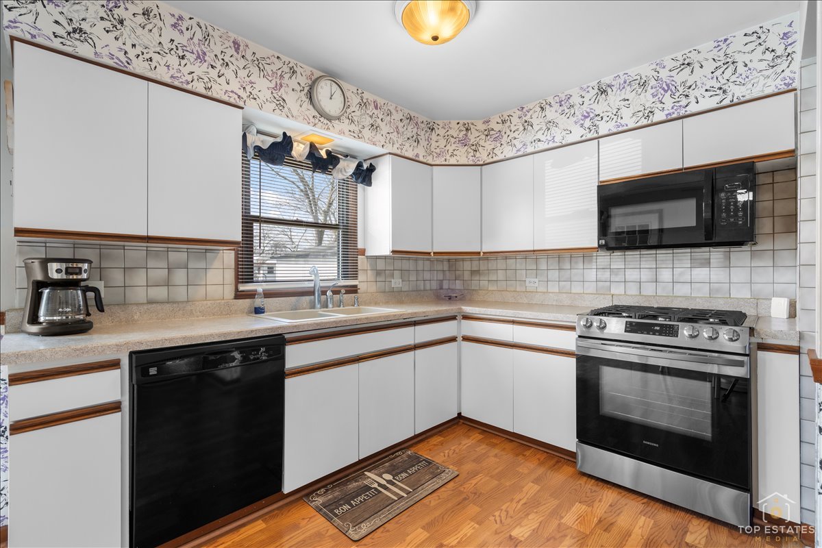 216 Evergreen Street Addison, IL 60101 - Photo 15 of 43 a kitchen with a stove and a sink
