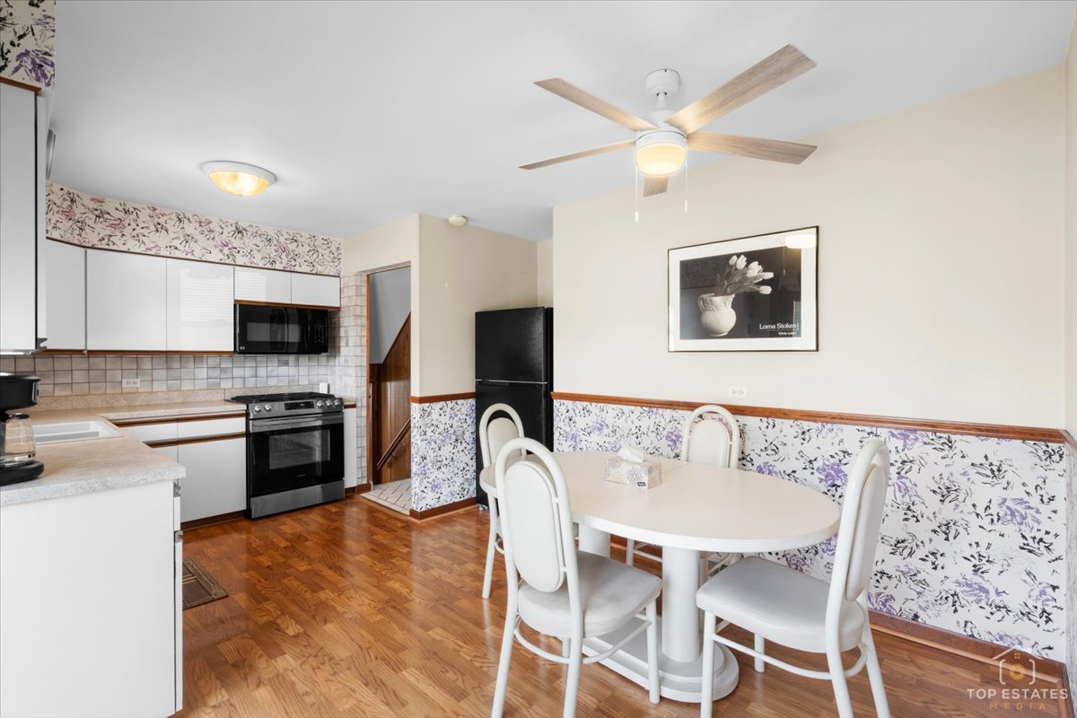 216 Evergreen Street Addison, IL 60101 - Photo 17 of 43 a dining room with furniture a window and a fireplace