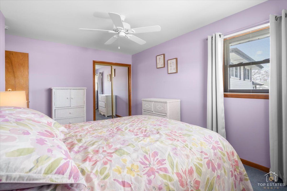 216 Evergreen Street Addison, IL 60101 - Photo 21 of 43 a bedroom with a bed and a chandelier