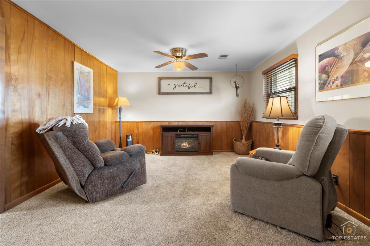 216 Evergreen Street Addison, IL 60101 - Photo 26 of 43 a living room with furniture a fireplace and a large window