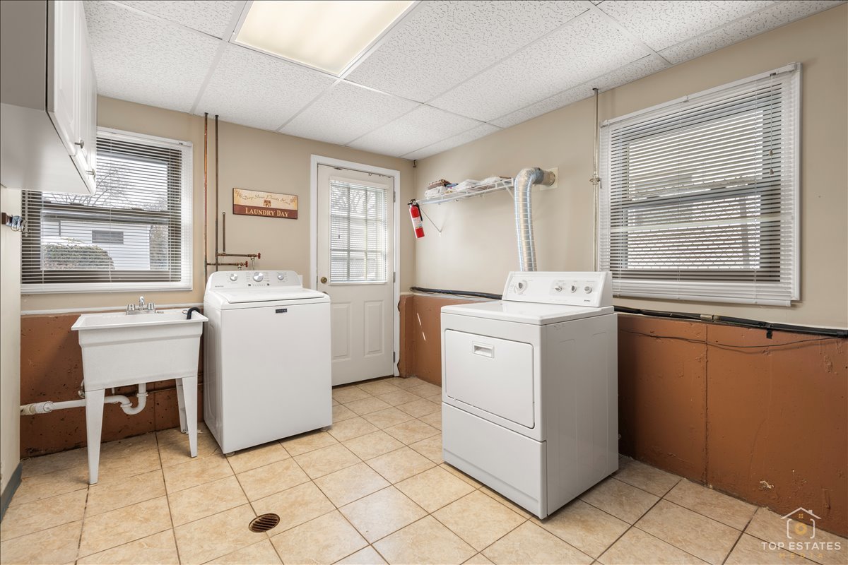 216 Evergreen Street Addison, IL 60101 - Photo 30 of 43 a utility room with cabinets dryer and washer