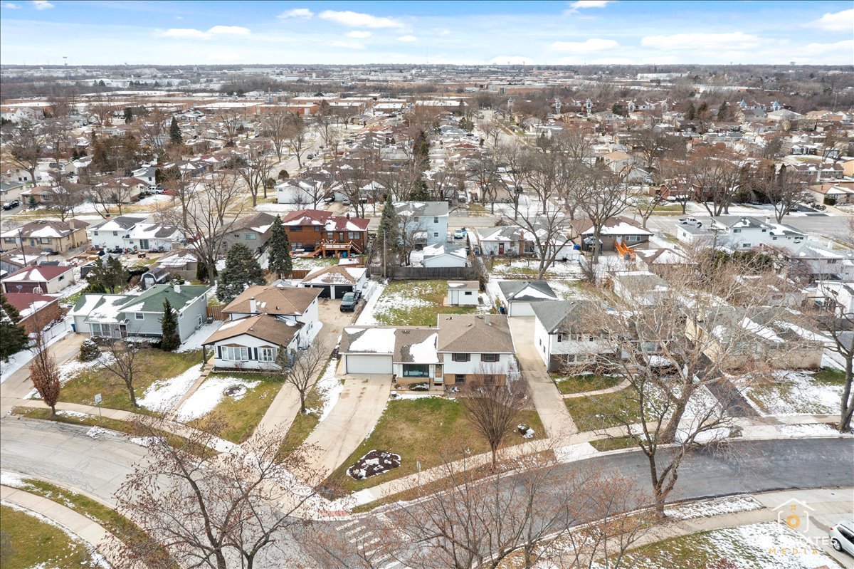 216 Evergreen Street Addison, IL 60101 - Photo 3 of 43 an aerial view of residential building and parking space