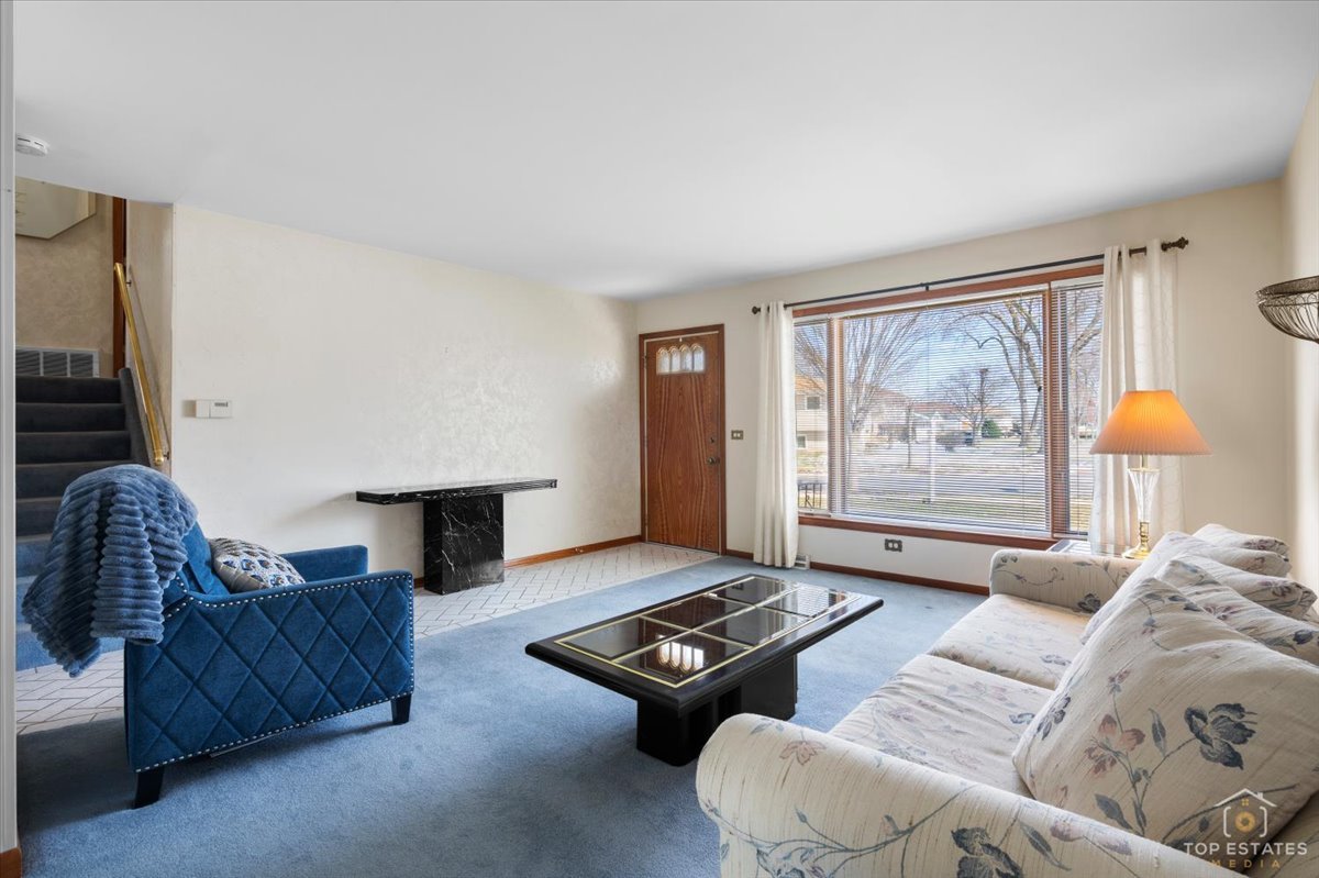 216 Evergreen Street Addison, IL 60101 - Photo 9 of 43 a living room with furniture and a window