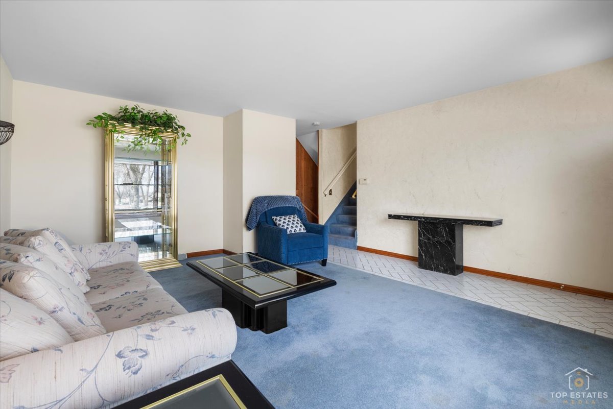 216 Evergreen Street Addison, IL 60101 - Photo 10 of 43 a living room with furniture and a window