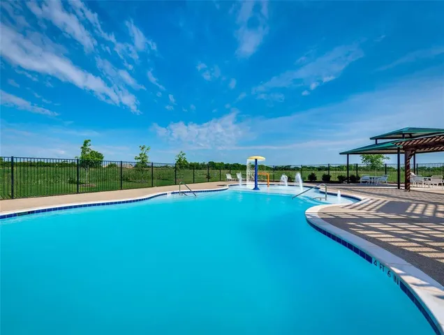 a view of a swimming pool and lounge chairs