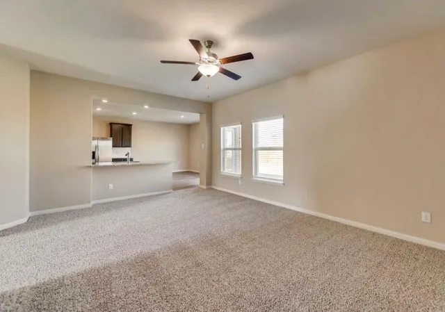 a view of a livingroom with a kitchen stove and a window