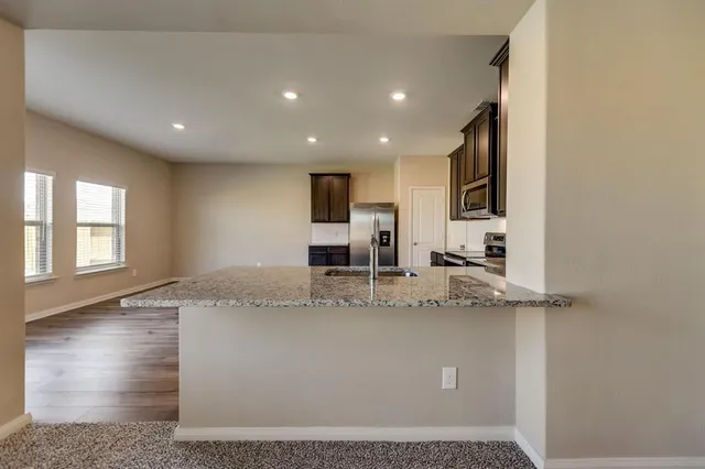 a view of a kitchen with a sink and a window