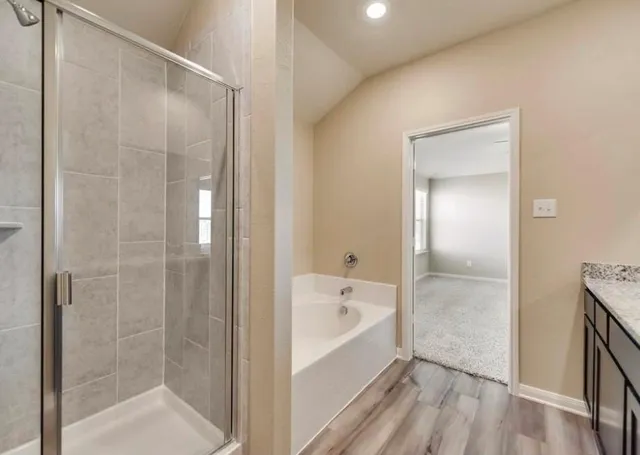 a bathroom with a bathtub and a shower