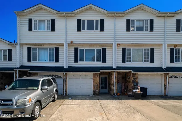 a front view of a house with parking space