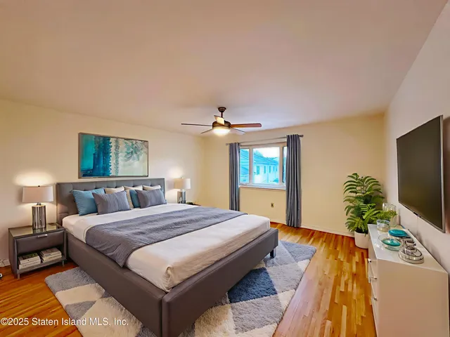 a view of a balcony with two chairs and a grill with wooden floor and fence