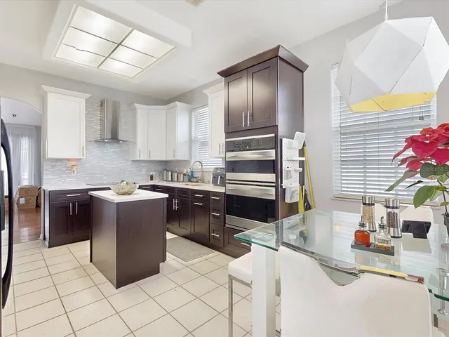 a kitchen with granite countertop a sink and a refrigerator