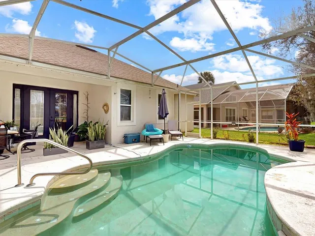 a view of a patio with swimming pool table and chairs