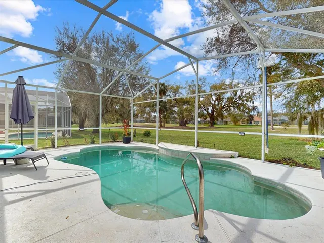 a view of a backyard with a swimming pool