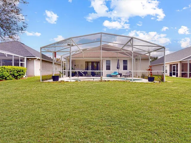 a swimming pool view with a seating space and a garden