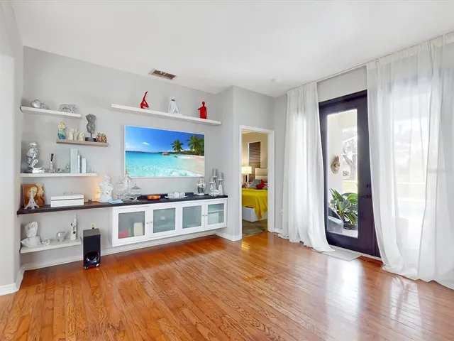 a kitchen with stainless steel appliances a stove and wooden floor
