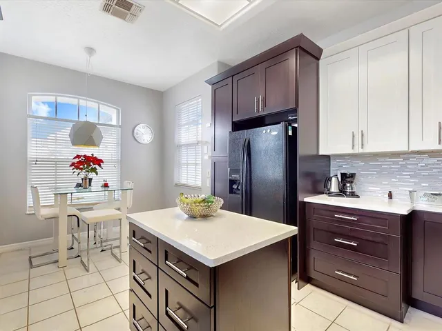 a kitchen with a sink a stove and cabinets