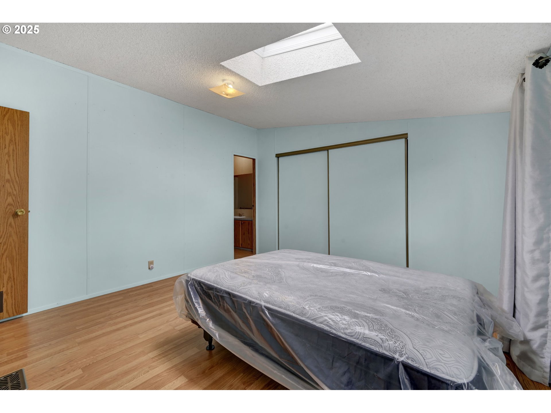 1120 West Fairview Drive, Unit 3 Springfield, OR 97477 - Photo 11 of 21 a bedroom with a bed and wooden floor