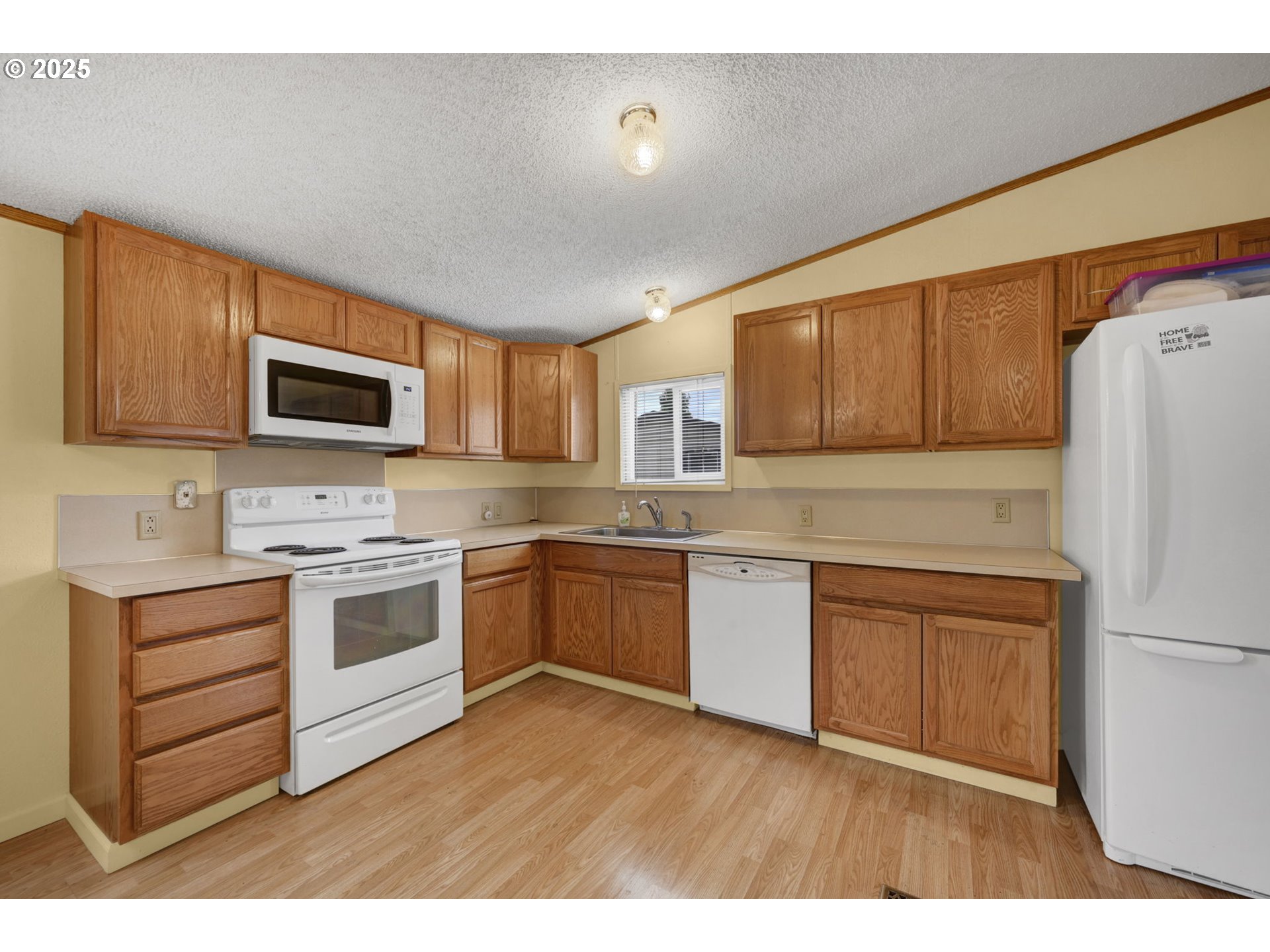 1120 West Fairview Drive, Unit 3 Springfield, OR 97477 - Photo 8 of 21 a kitchen with granite countertop a refrigerator stove top oven and sink