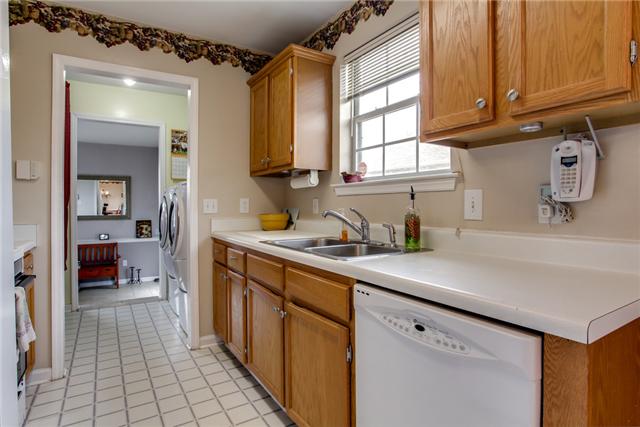 3479 Beckwith Road Mount Juliet, TN 37122 - Photo 4 of 20 a kitchen with stainless steel appliances a sink dishwasher and cabinets with wooden floor
