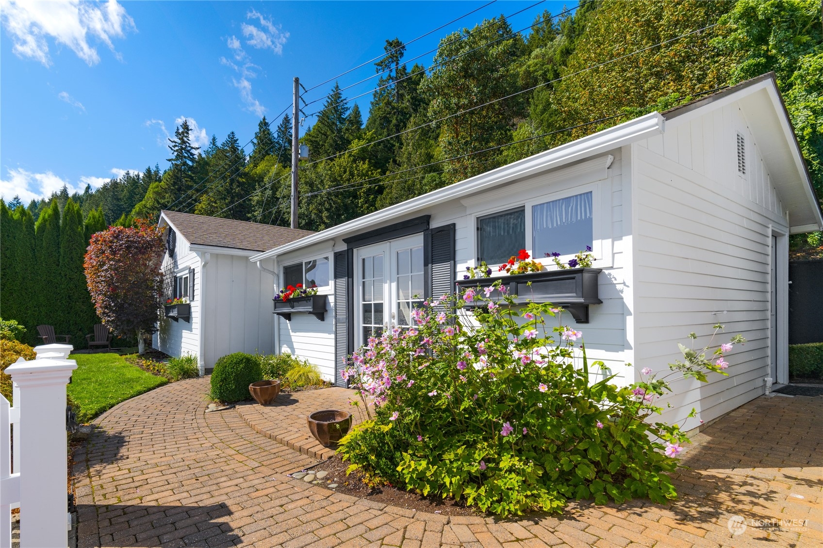 7681 Northeast North Shore Road Belfair, WA 98528 - Photo 15 of 40 a front view of a house with garden