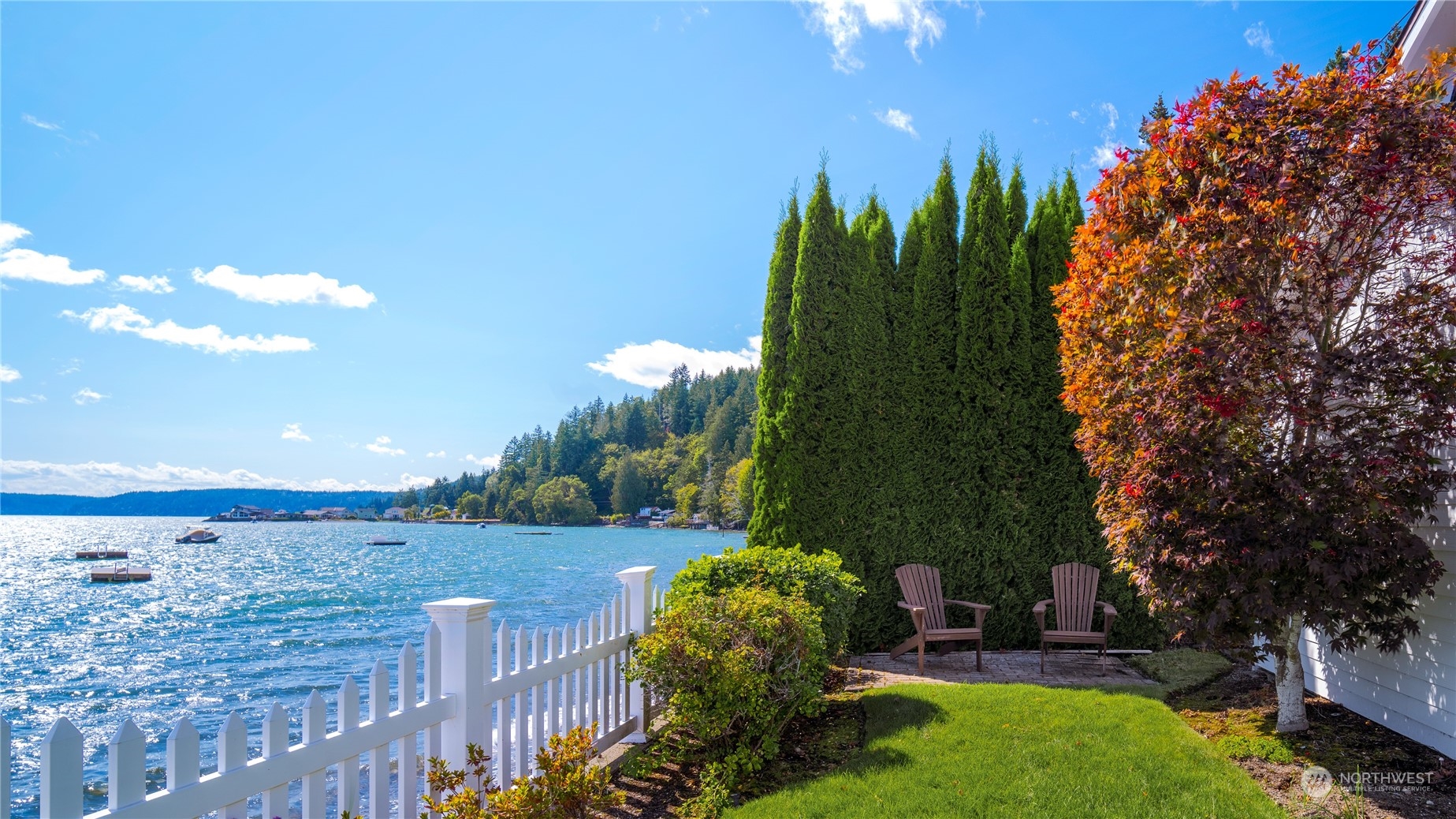 7681 Northeast North Shore Road Belfair, WA 98528 - Photo 25 of 40 a backyard of a house with lots of green space and outdoor seating