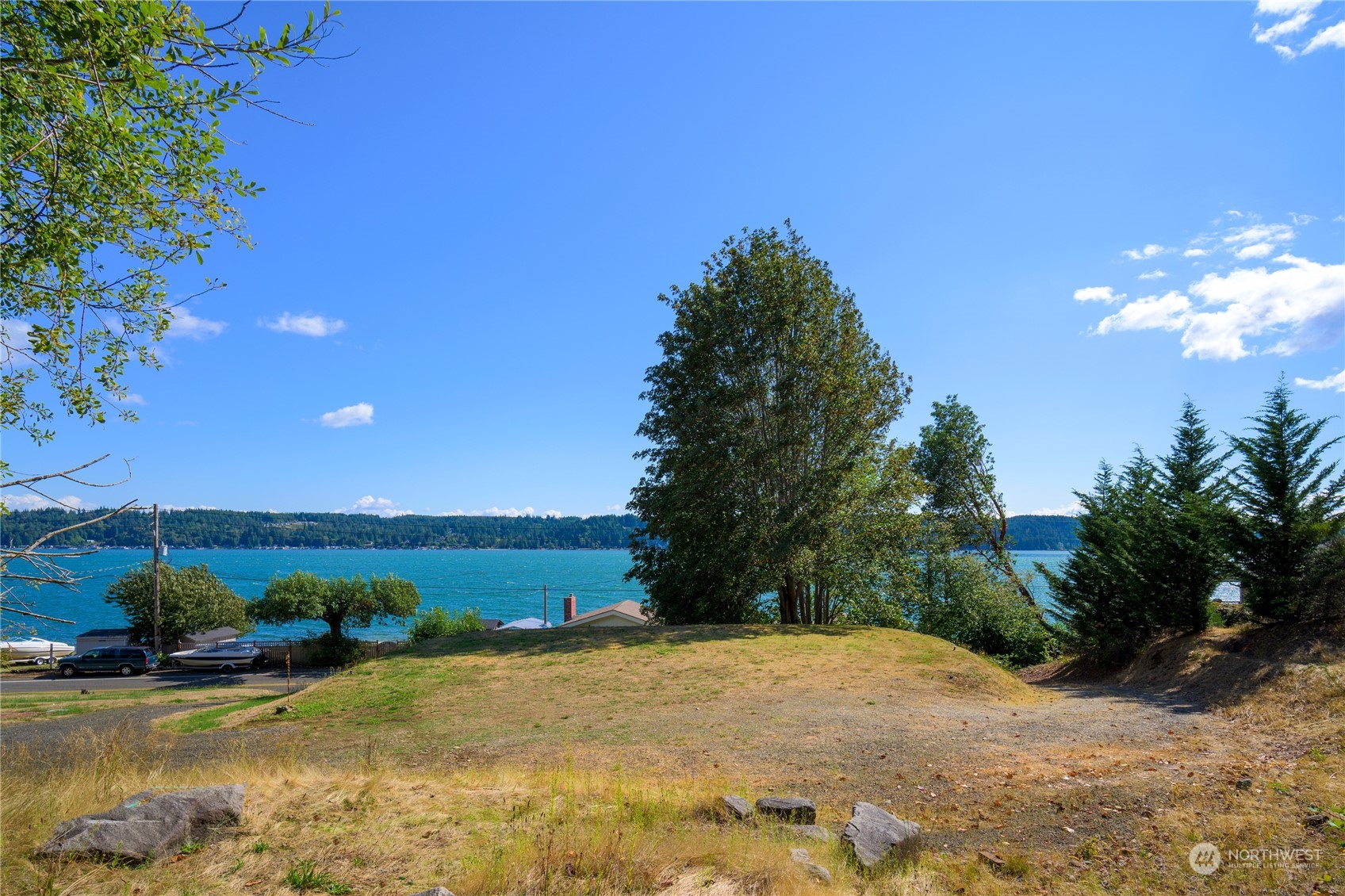 7681 Northeast North Shore Road Belfair, WA 98528 - Photo 37 of 40 a view of a lake with a house in the background