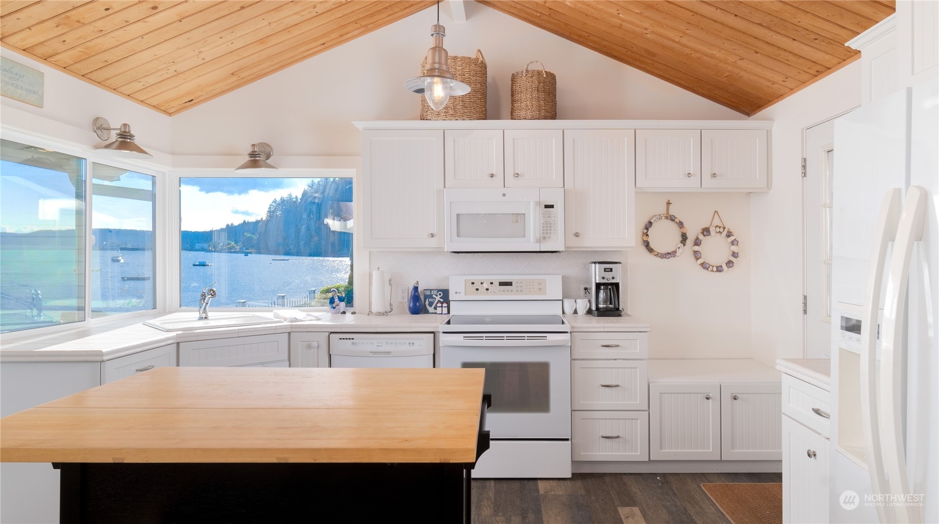 7681 Northeast North Shore Road Belfair, WA 98528 - Photo 6 of 40 a kitchen with stainless steel appliances white cabinets and a refrigerator