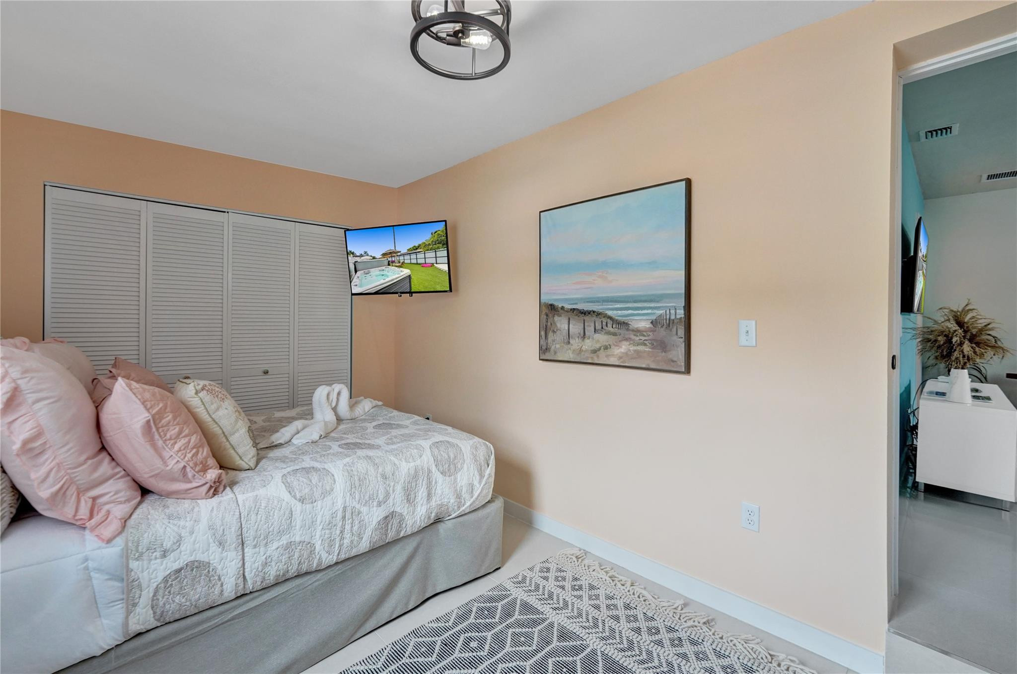 8236 Northwest 1st Place, Unit 2 Miami, FL 33150 - Photo 12 of 22 a bedroom with a bed and a painting on the wall