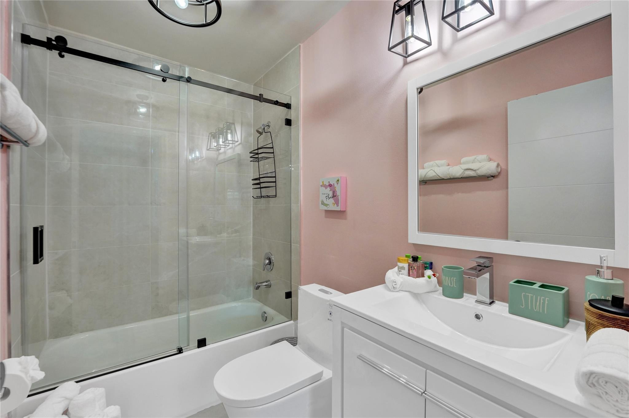8236 Northwest 1st Place, Unit 2 Miami, FL 33150 - Photo 13 of 22 a bathroom with a bathtub shower sink vanity and toilet