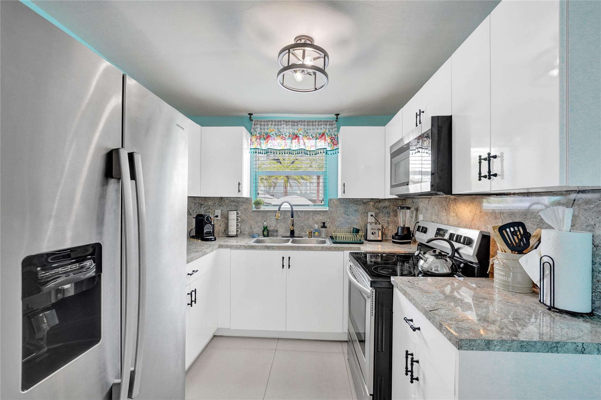 8236 Northwest 1st Place, Unit 2 Miami, FL 33150 - Photo 17 of 22 a kitchen with stainless steel appliances granite countertop a sink a stove and refrigerator