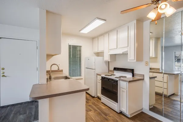 a kitchen with stainless steel appliances granite countertop a sink and a window