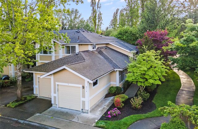 a aerial view of a house with a yard and potted plants