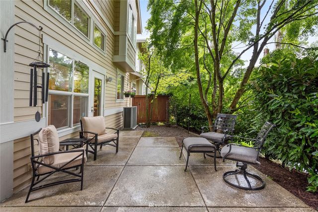 a view of a patio with table and chairs and potted plants