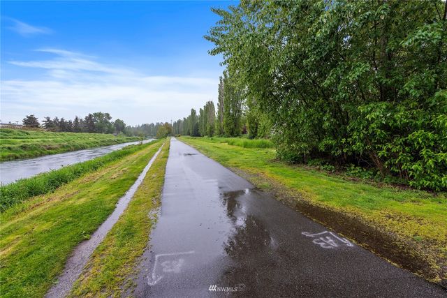 a view of a street with a big yard