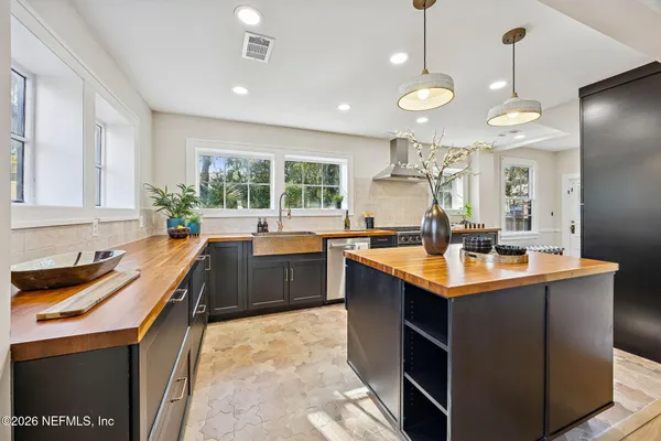 a kitchen with counter top space sink stove and refrigerator