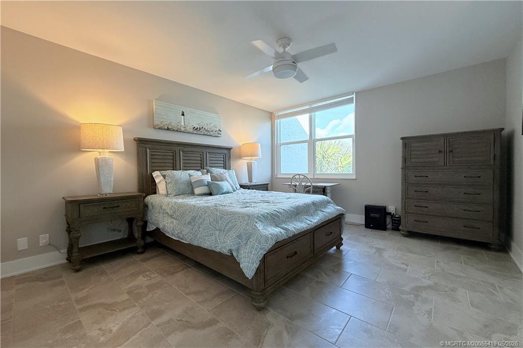 1950 Southwest Palm City Road, Unit 14305 Stuart, FL 34994 - Photo 32 of 70 a bedroom with a bed and a ceiling fan