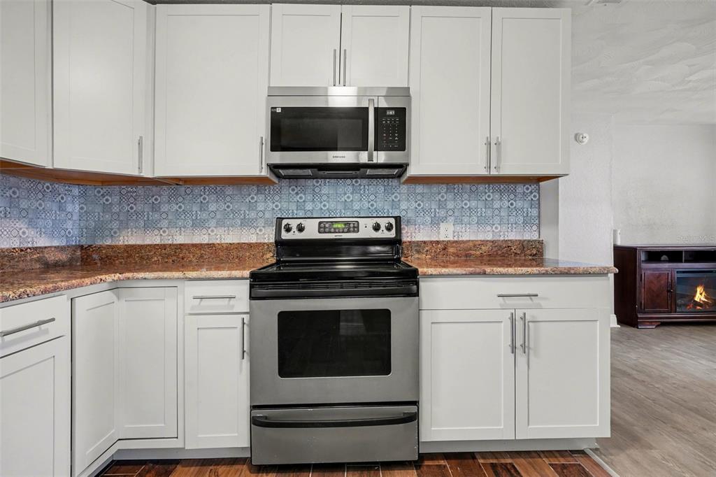 355 South Oak Avenue Frostproof, FL 33843 - Photo 12 of 35 a kitchen with white cabinets and appliances