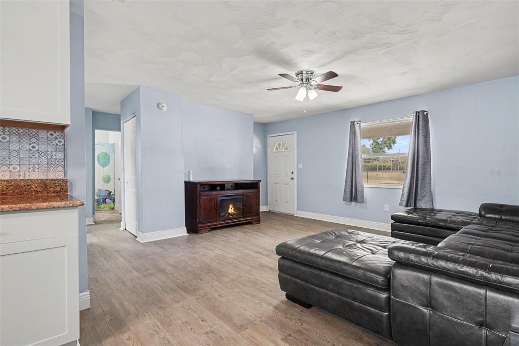 355 South Oak Avenue Frostproof, FL 33843 - Photo 15 of 35 a living room with furniture and a chandelier