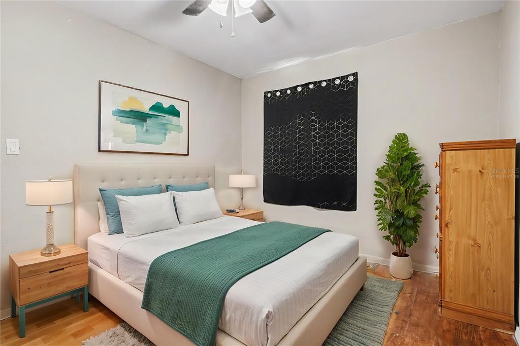 355 South Oak Avenue Frostproof, FL 33843 - Photo 17 of 35 a bedroom with a large bed and a potted plant