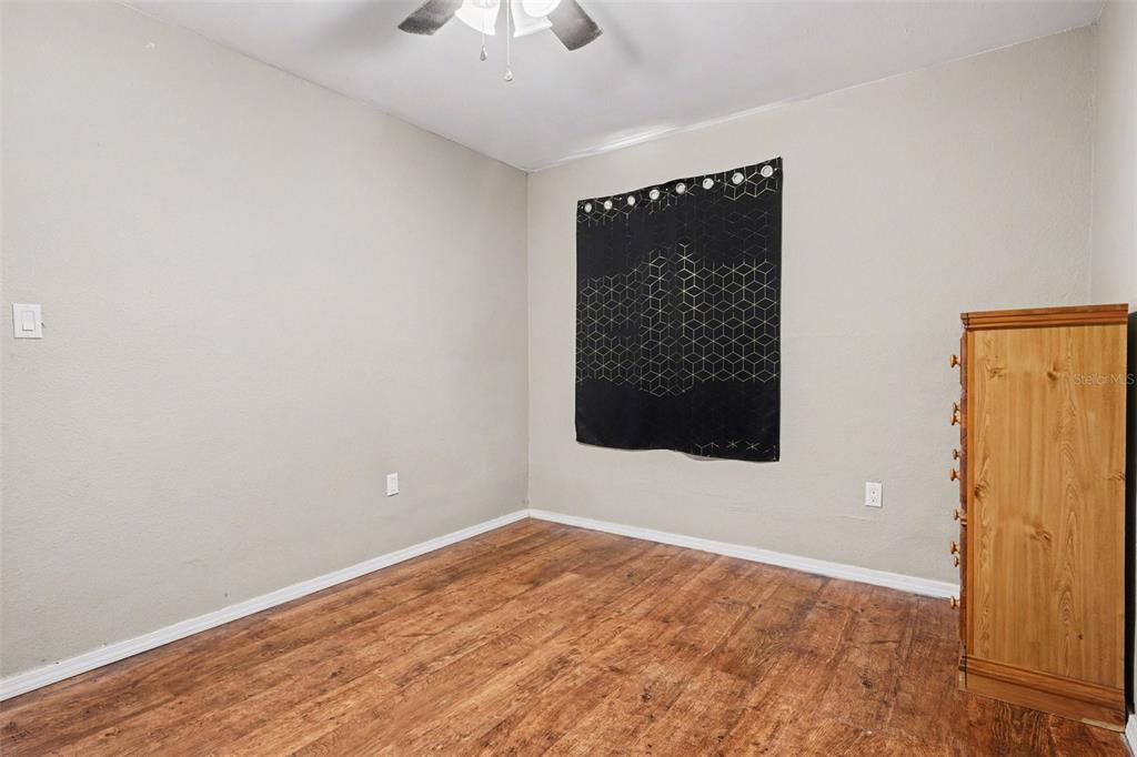 355 South Oak Avenue Frostproof, FL 33843 - Photo 20 of 35 an empty room with wooden floor and windows