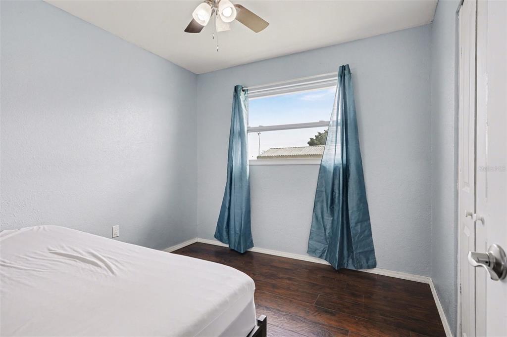 355 South Oak Avenue Frostproof, FL 33843 - Photo 23 of 35 a bedroom with a bed and a chandelier fan
