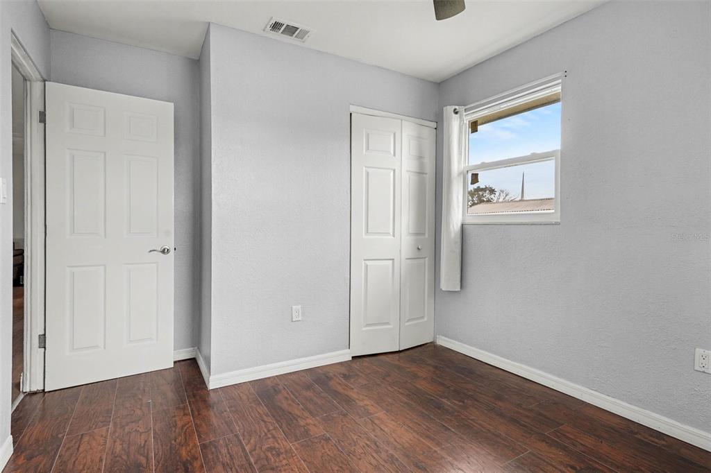 355 South Oak Avenue Frostproof, FL 33843 - Photo 28 of 35 a view of an empty room with wooden floor and a window