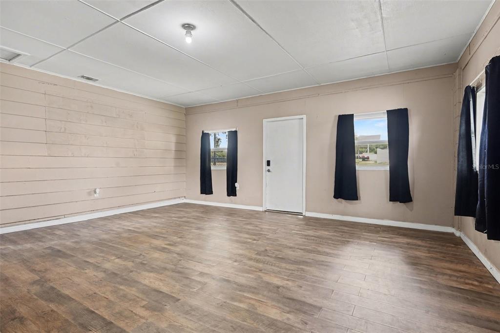 355 South Oak Avenue Frostproof, FL 33843 - Photo 4 of 35 a view of an empty room with window and wooden floor