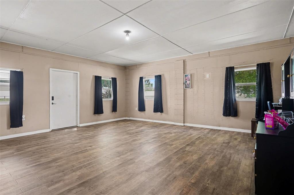355 South Oak Avenue Frostproof, FL 33843 - Photo 5 of 35 a view of an empty room with window and wooden floor