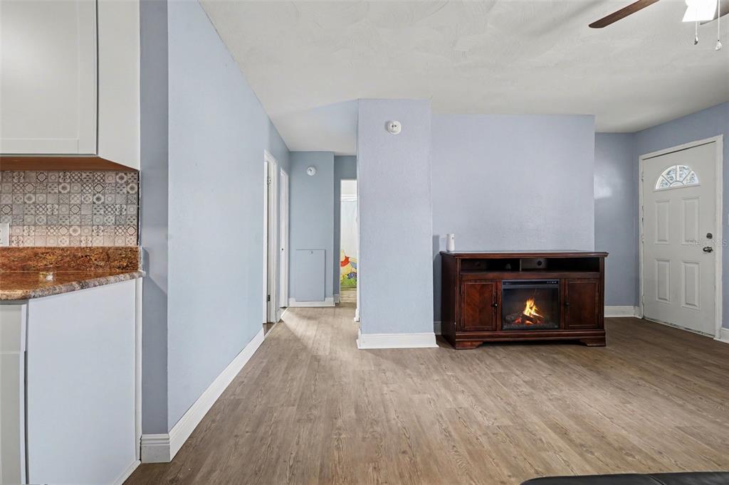 355 South Oak Avenue Frostproof, FL 33843 - Photo 8 of 35 a view of an empty room with wooden floor and a fireplace
